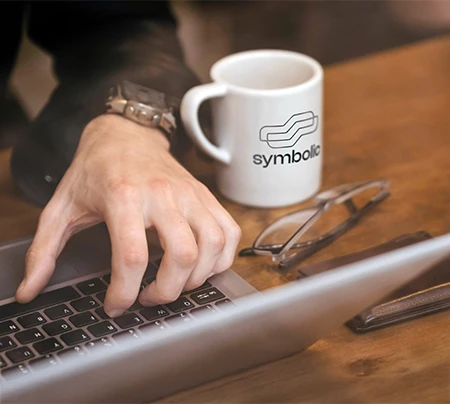 Symbolic Branding Office a close-up hand working in a Laptop